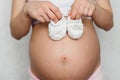 Booties for newborn in the hands of a pregnant girl Royalty Free Stock Photo