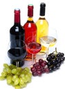 Bootles and glasses of wine with black, red and white grapes Royalty Free Stock Photo