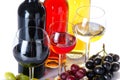 Bootles and glasses of wine with black, red and white grapes Royalty Free Stock Photo
