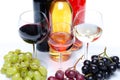 Bootles and glasses of wine with black, red and white grapes Royalty Free Stock Photo