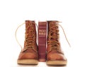 Boots and bible isolated against white Royalty Free Stock Photo