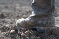 Boots on dry earth. Royalty Free Stock Photo
