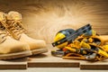 Boots and earphones on tool belt with construction tools Royalty Free Stock Photo