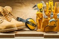 Boots earphones and toolbelt with construction tools Royalty Free Stock Photo