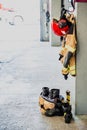 Boots and fireman`s jacket on the garage floor of a fire station