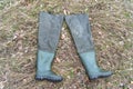 Boots for fishing on dry grass Royalty Free Stock Photo