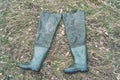 Boots for fishing on dry grass Royalty Free Stock Photo