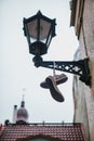 Boots hang on the old lamp. Creative idea. Decoration of the house