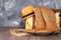 boots, hat and a canvas bag against a gray wall. Adventure and travel concept. Space for text Royalty Free Stock Photo