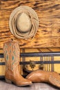 Boots, hat, and vintage suitcase against a wooden wall. The concept of adventure and travel Royalty Free Stock Photo