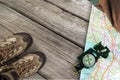 Hiking boots, compass and map on background