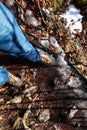 boots and legs with jeans of the adventurous hiker on the impervious path during the mountain excursion Royalty Free Stock Photo