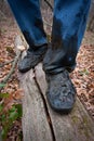 Boots men in the dirt on a log in forest Royalty Free Stock Photo