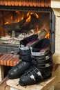 Boots ski boots in front of fireplace Royalty Free Stock Photo