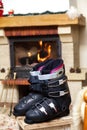 Boots ski boots in front of fireplace Royalty Free Stock Photo