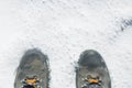 Boots in the snow. Feet isolated on white background with copy space. Winter adventure sports Royalty Free Stock Photo