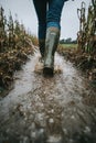 Boots Walking Through Mud in a Field: Dynamic Agricultural Work Royalty Free Stock Photo