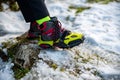 Boots with yellow crampons, winter trekking in the mountains.
