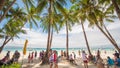 BORACAY, PHILIPPINES - JANUARY 7, 2018 - Tourists relaxing on the paradise shore of the White Beach in Boracay Royalty Free Stock Photo