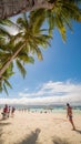 BORACAY, PHILIPPINES - JANUARY 7, 2018 - Tourists relaxing on the paradise shore of the White Beach in Boracay Royalty Free Stock Photo