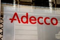 Adecco sign brand and text logo on building facade of famous french Temporary work