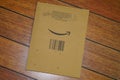 Amazon logo sign arrow smile printed on an envelope brown cardboard box side