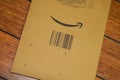 Amazon logo with sign arrow smiling printed on envelope brown cardboard