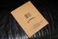 Amazon logotype printed on an envelope brown cardboard box side