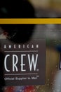 American Crew logo brand and text sign on windows entrance salon barber shop official