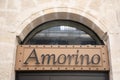 Amorino logo brand and facade sign text of Italian cafe of Gelato Ice cream wall