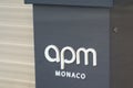 Apm monaco logo and sign text front of store fashion brand clothes shop in street view