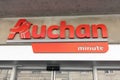 Auchan minute logo brand and text sign facade of French group of local city