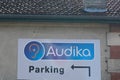 Audika logo brand and text sign parking front of store hearing aid distribution shop