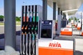 Avia logo text and brand sign on petrol gas pump nozzles on fuel service station