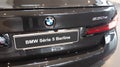 BMW 5 serie car exterior details logo and sign on rear in dealership showroom