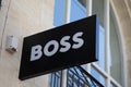 boss logo brand and text sign on wall facade shop entrance in city