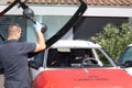 Bordeaux , Aquitaine / France - 04 26 2020 : carglass man worker replace remove crashed windshield of car in home office customers