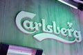 Carlsberg beer irish sign text and brand logo on facade wall building bar entrance pub