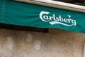 Carlsberg beer sign text and brand logo on flag facade bar pub restaurant