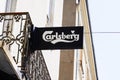 Carlsberg text and sign logo of beer front of bar restaurant in french street for pub Royalty Free Stock Photo