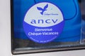 Cheque vacances ancv logo brand and text sign of acceptance voucher on facade entrance