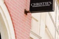 christies sign text and logo of real estate luxury store wall brick christie`s