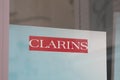 Clarins beauty shop brand logo and text sign on facade windows entrance store