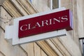 Clarins beauty shop brand logo and text sign on wall facade entrance store