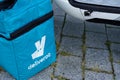 Deliveroo blue bag of bagpack man bike deliver for restaurant British online food