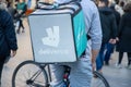 Deliveroo logo brand and text sign on bag man cooler backpack restaurant delivery on