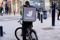 Deliveroo logo and text sign on back bag cargo box man delivery on bike