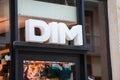 dim logo brand and text sign on wall facade shop entrance in city