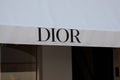 dior store sign text and logo brand of designer fashion store front chain entrance