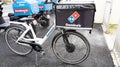 Dominos pizza bicycle with text sign of restaurant Domino`s us pizza chain with